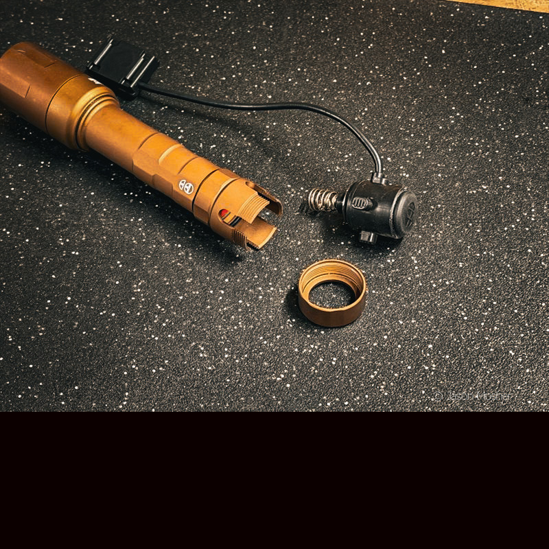 A brown light on a black surface with the tail switch removed. 