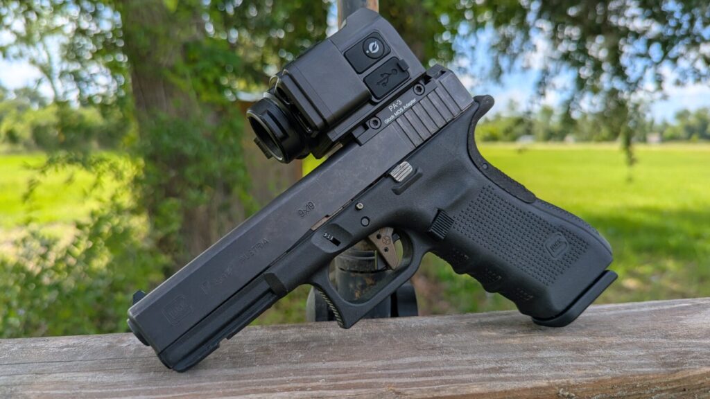 Left-side profile of a full-size Glock 17 Gen 4 9mm pistol resting on a wooden bench, with the ultra-compact Mars Mini thermal optic mounted directly onto the MOS slide cut.