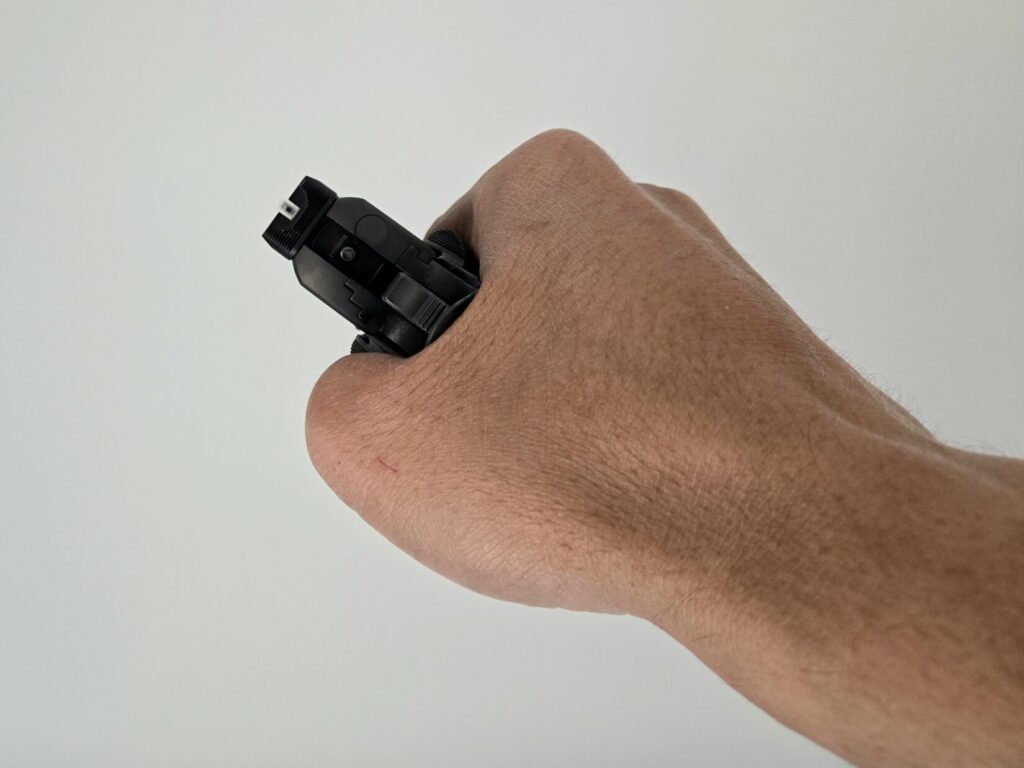 A pistol held with a slight cant against a white backdrop