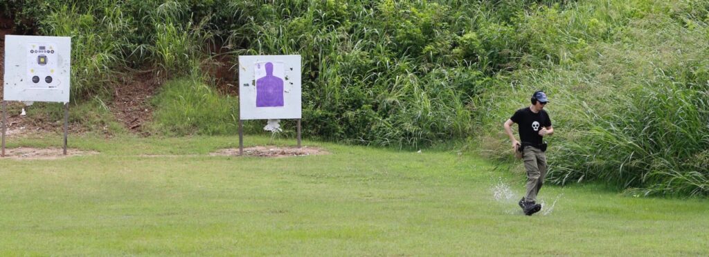 A shooter three-quarters through a 150-yard sprint with six strings of fire, training under elevated heart rate