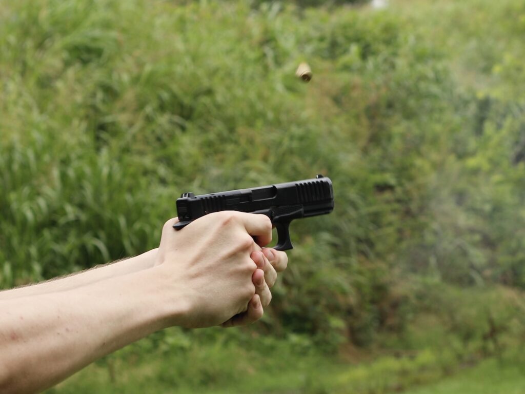 A handgun firing on the range, illustrating how fine motor skills decline as heart rate rises under stress
