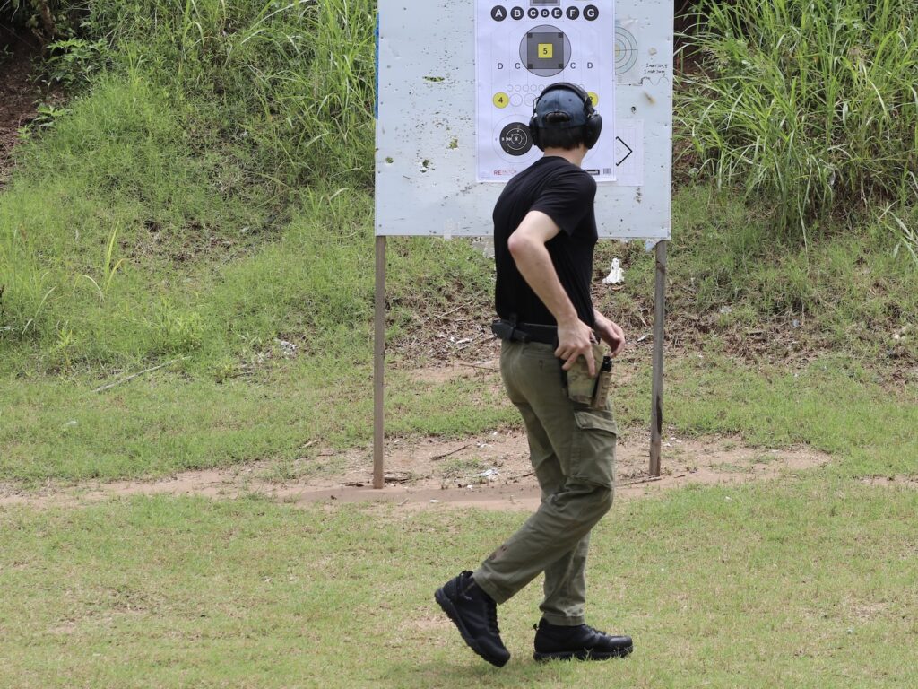 A shooter performing a turn-and-draw drill with the muzzle kept downrange, a good entry point for movement-based training