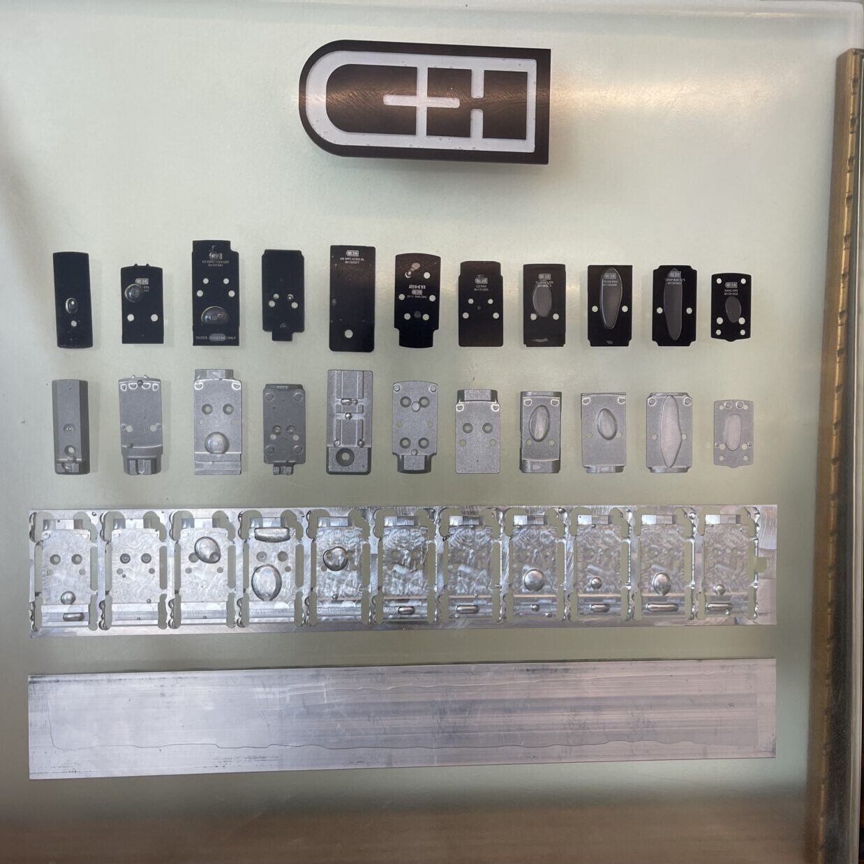 Pictured is some C&H adapter plates from raw material to finished products ready to mount red dot sights
