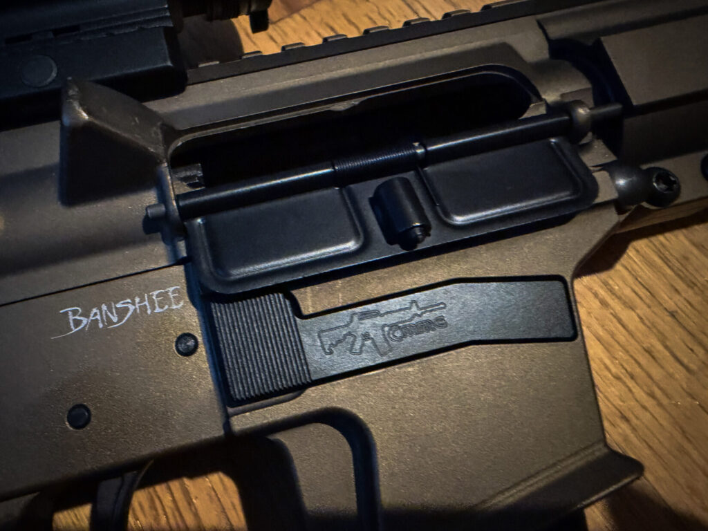 bronze-colored CMMG banshee on a wood background