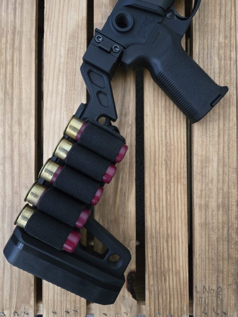 A shotgun buttstock with 5 spare shotgun shells.