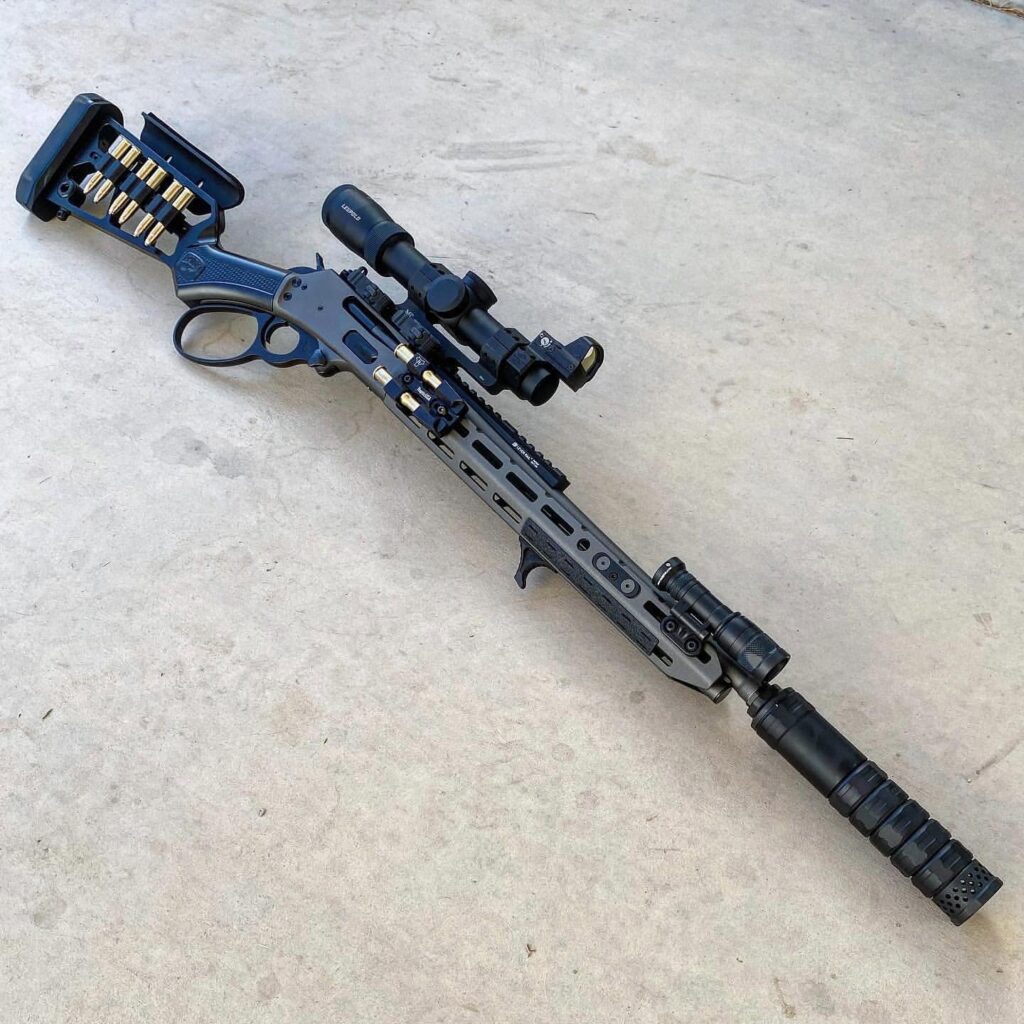 A lever action rifle with suppressor and LPVO with MRDS and weaponlight