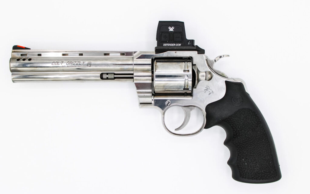 Revolver with red dot on a white background.