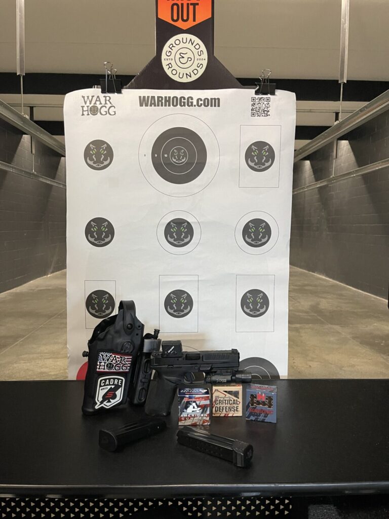 Pictured is a pistol, ammo, War HOGG Tactical training target and a Safariland holster at Grounds&Rounds Range