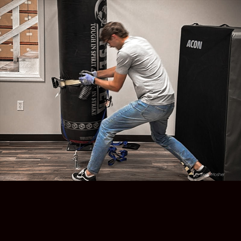 A Safariland tester pulling a holstered handgun from multiple angles during a retention pull test