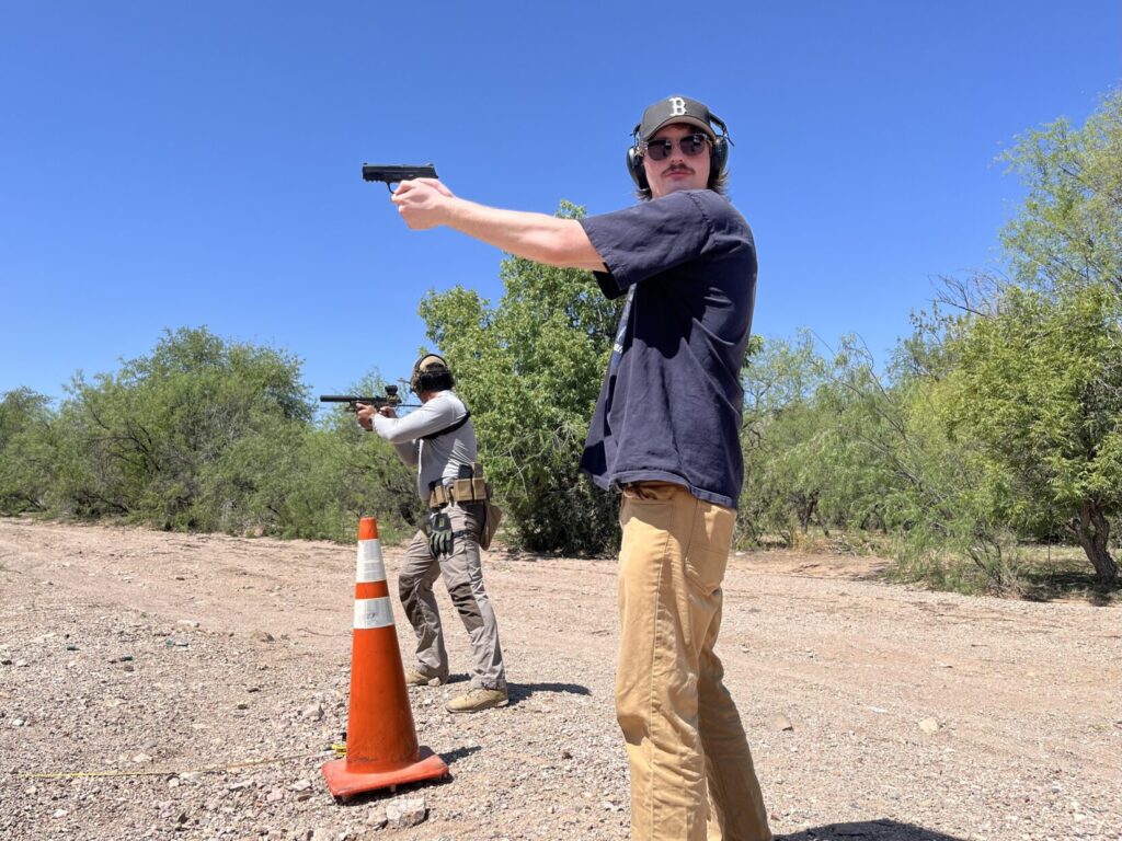 Two shooters keep the targets they just shot covered while each looks around his side of the environment to ensure they are safe.