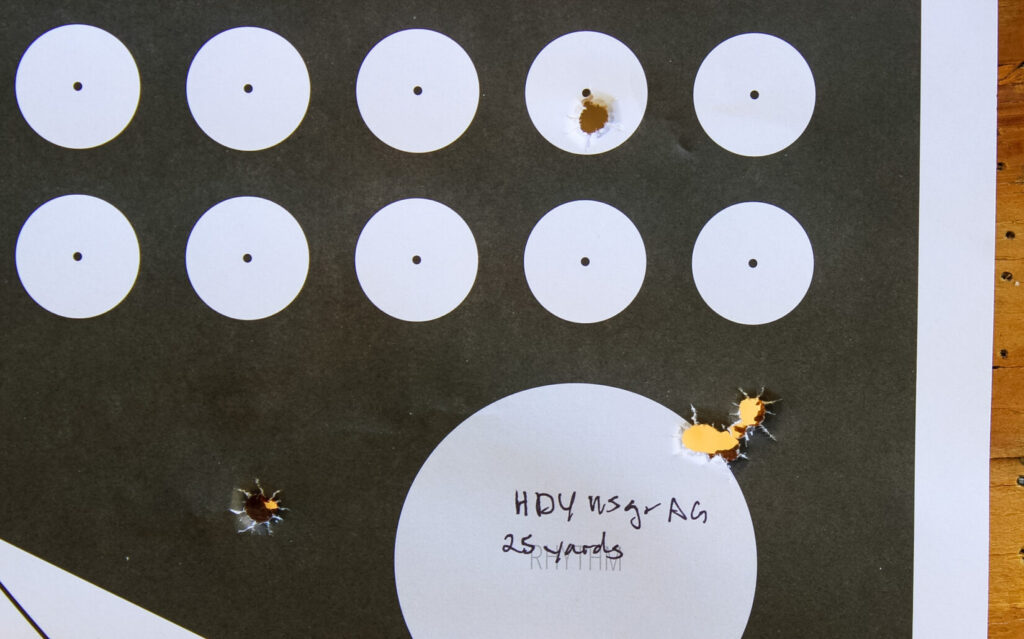 Target showing the MAC 9 DS Comp's 25-yard accuracy test, with a tight three-round cluster and two thrown shots