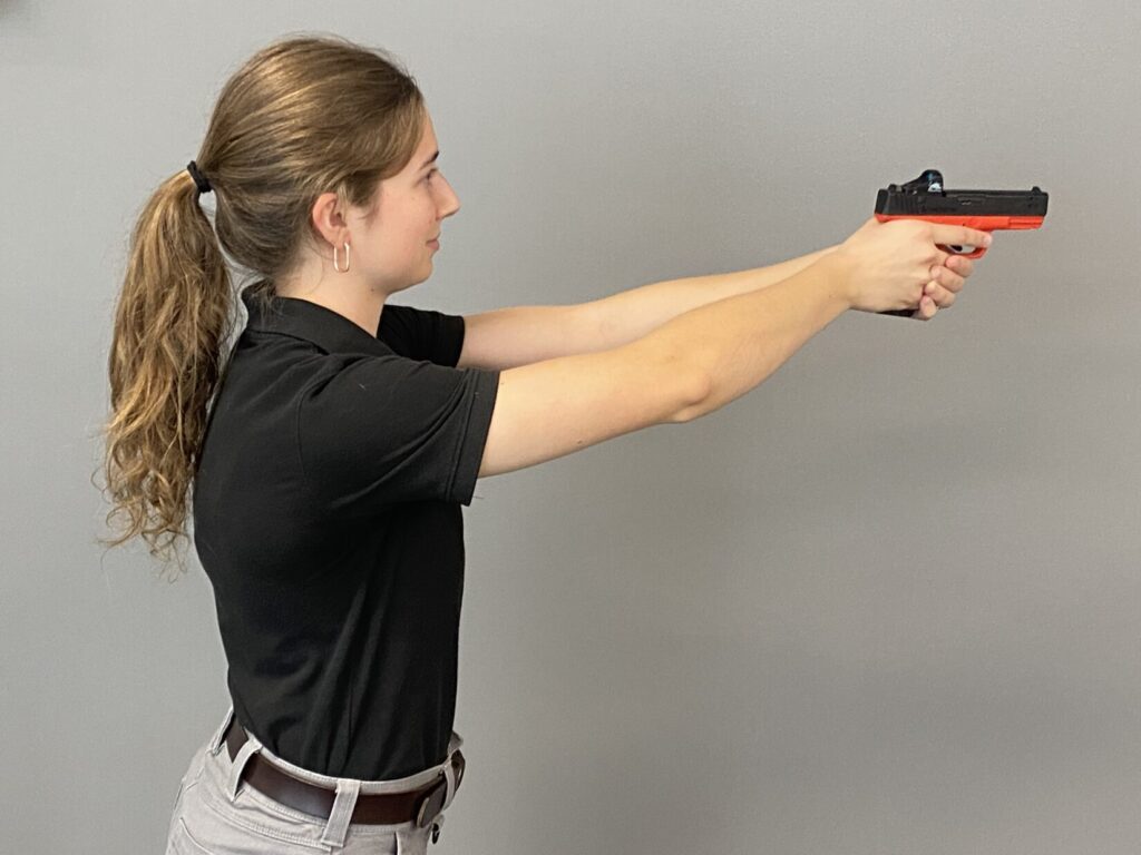 Shooter practicing pistol-mounted optic presentation drills with Mantis TitanX