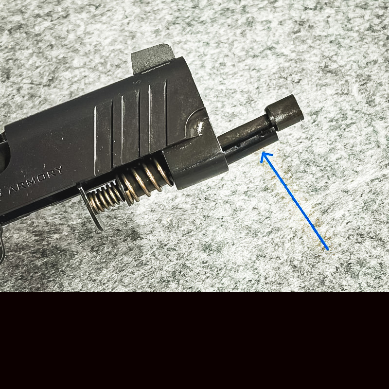 A view of the recoil spring compressed with a plastic sleave made to hold it in position.