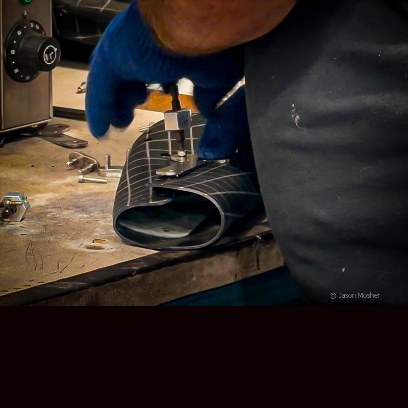 The heated Boltaron sheet folded and held together with a metal brace before its second oven pass