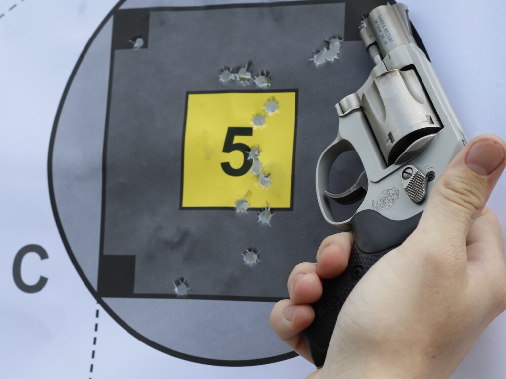 a smith & wesson J-frame next to a target