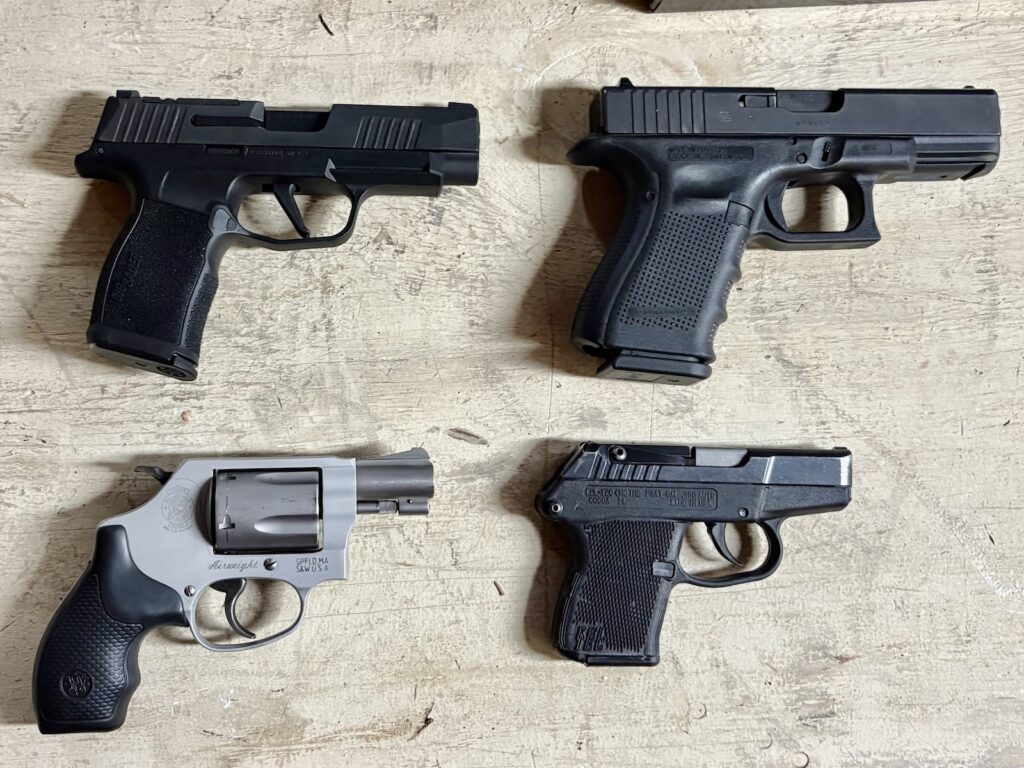 a glock 19, a sig p365, a smith J-frame, and a kel-tec p3at