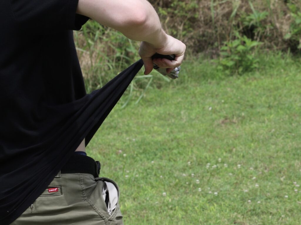 a revolver snagged in a shirt on the draw
