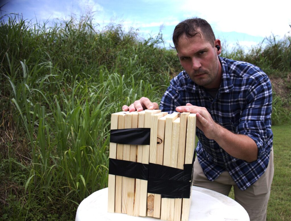 Jim showing two stacks of six one inch pine boards bound in duct tape