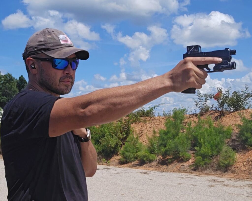 A man in a black shirt shooting with his right hand only