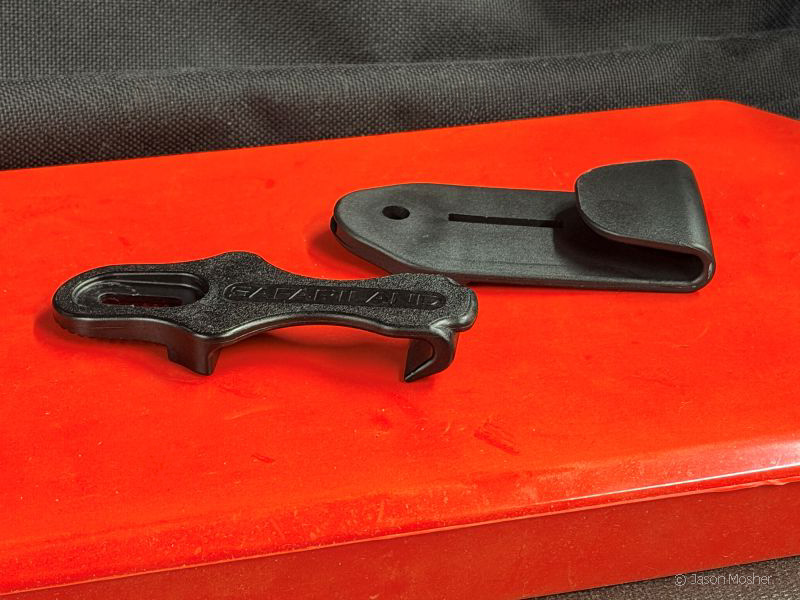 Two black belt clips for the Pro-Fit holster on a red display box.