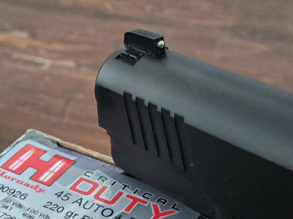 A 1911 front sight and a box of ammo