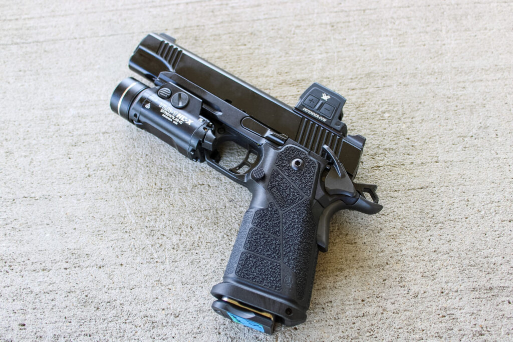 The Kimber DS Warrior LW, showing its traditional 1911 lines against a concrete background