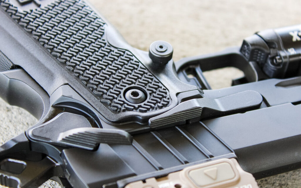Close-up of the MAC 9 DS Comp's oversized, extended slide release and magazine release controls