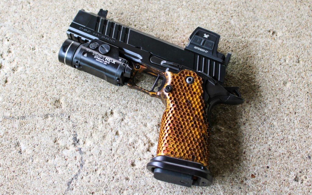 The MasterPiece Arms DS9-TC Hybrid on a concrete bench, showing its honeycomb texturing