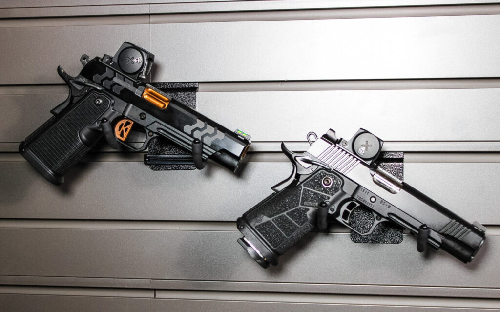 Assortment of pistols on a grey background.