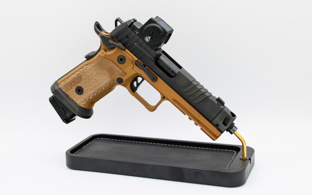 The Sig Sauer P211 GTO Combat with MACH3D compensator and Coyote Brown frame on a display stand