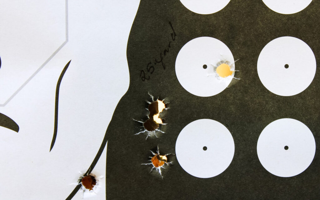 Target showing the Springfield Prodigy's 3.25-inch group at 25 yards, with one hit on the bullseye