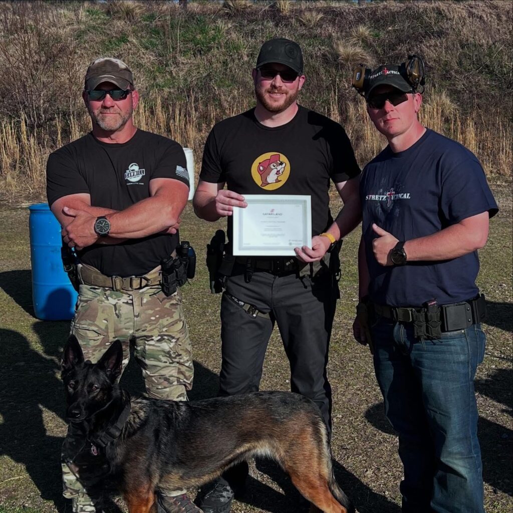 Ken Stretz and "Dutch" Moyer present a Safariland gift certificate to the Top Shooter in their "Collab Pistol Class" in Laurens, South Carolina.