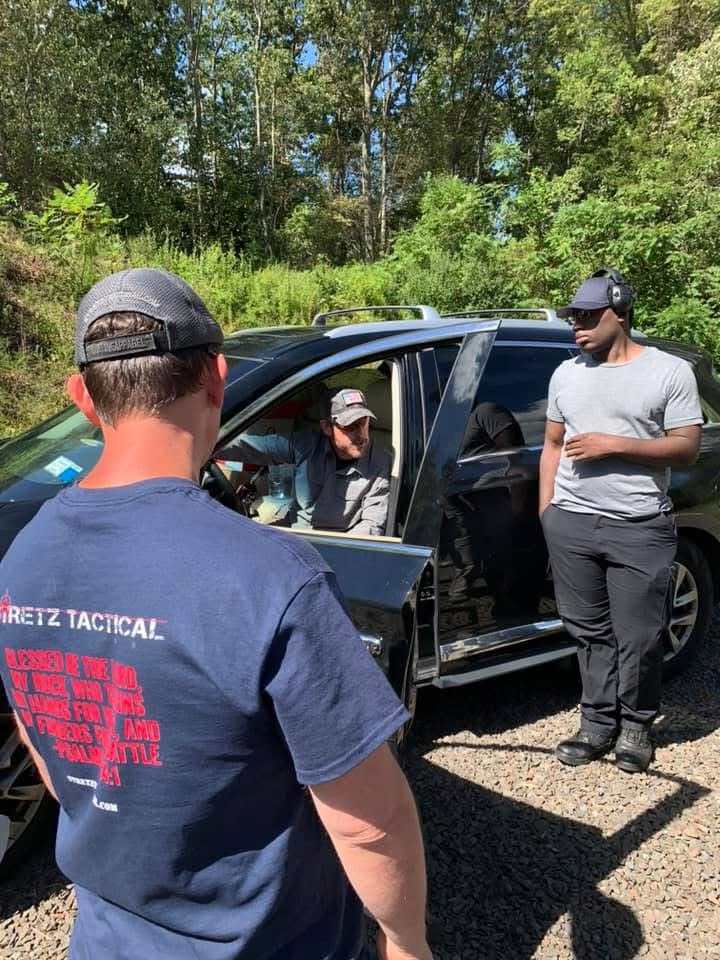 Ken Stretz of Stretz Tactical and Rick Hogg of War Hogg Tactical discussing concealed carry technique inside a vehicle during a collab training course.