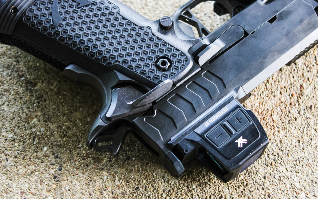 The VKTR VKP on a concrete bench, showing its oversized slide release and ambidextrous safety