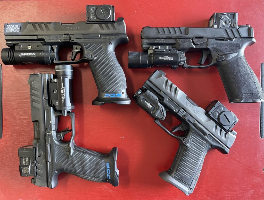A lineup of pistol mounted lights showing different switch designs and activation styles