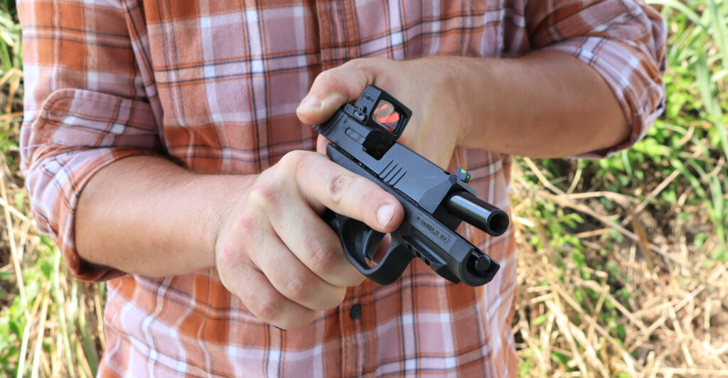 Racking the slide of the FN 309 MRD, showing its light recoil spring and easy slide manipulation
