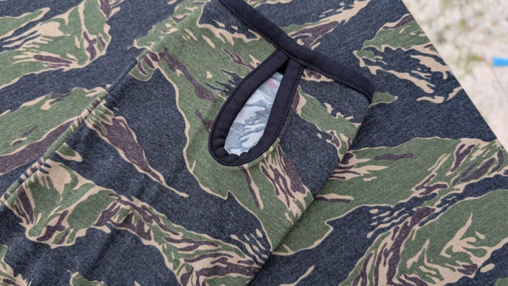 Detailed shot of the sleeve cuff on the tiger stripe camo hoodie showing the thumb hole opening with black trim.
