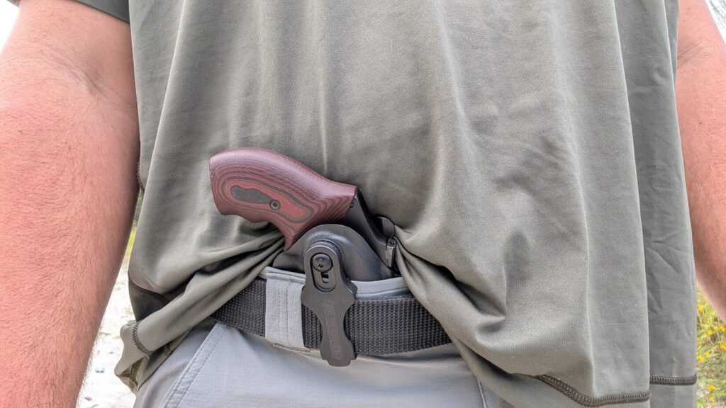 Front view of a person wearing the J-frame revolver in an inside-the-waistband Safariland holster attached to a belt.