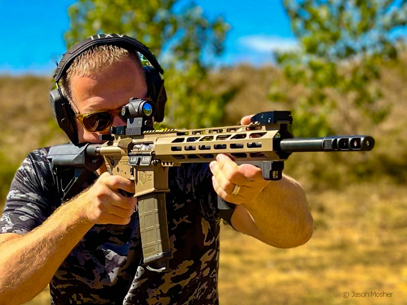 Man in a camo shirt, shooting a tan DB15 rifle a the range.
