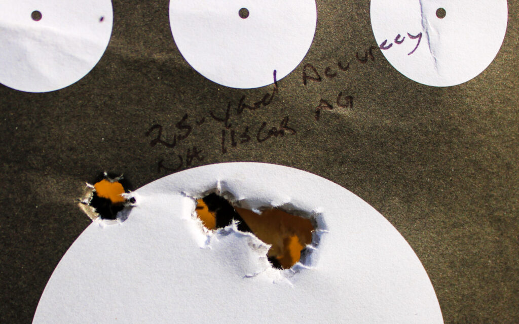 Twenty-five-yard accuracy target showing a five-shot group measuring 1.25 inches center to center.