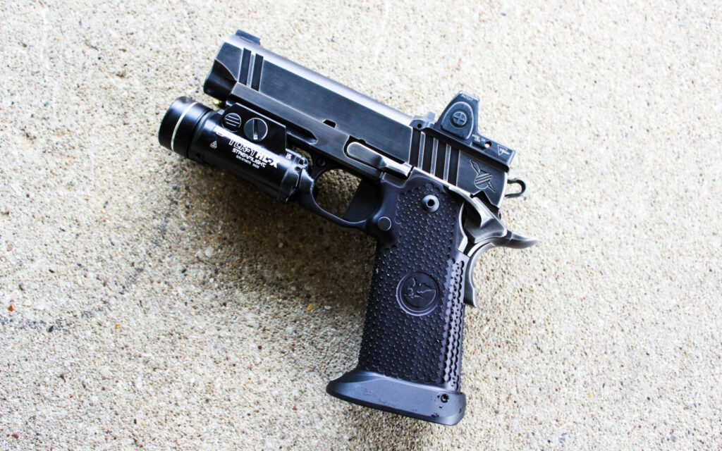 Nighthawk Custom Combat Special resting on a concrete bench, showing the polished fit and finish.