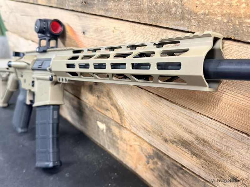 A close up view of the tan M-Lok handguard on the Diamondback DB15 rifle.