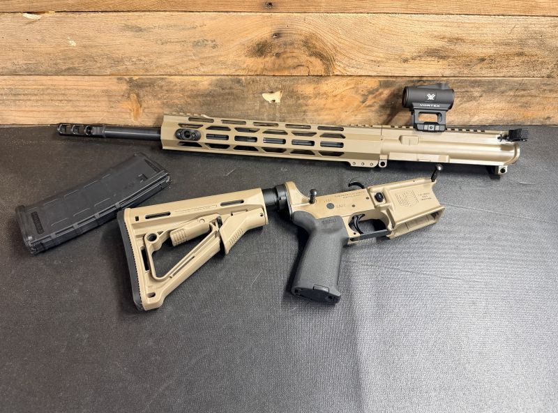 Tan Diamondback DB15 rifle broken down into three parts on a black surface