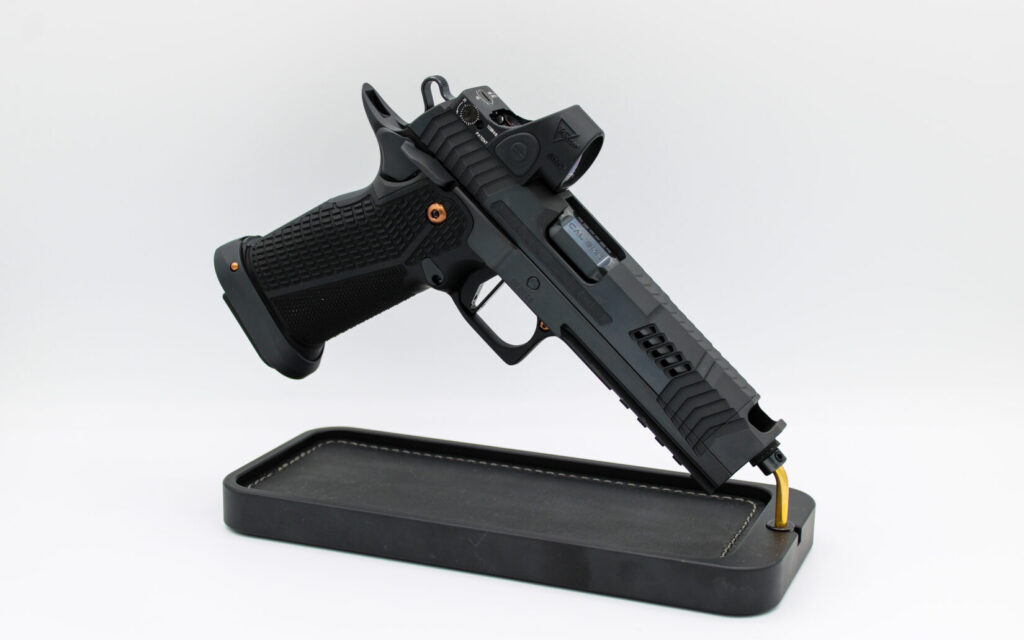 Dark Forge Reaper 2011 pistol on a black rest on a white background.