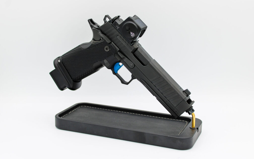 Miller Precision Ranger 9X 2011 pistol on a black rest on a white background.
