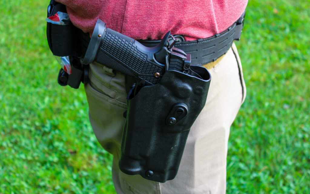A black pistol in a black holster.