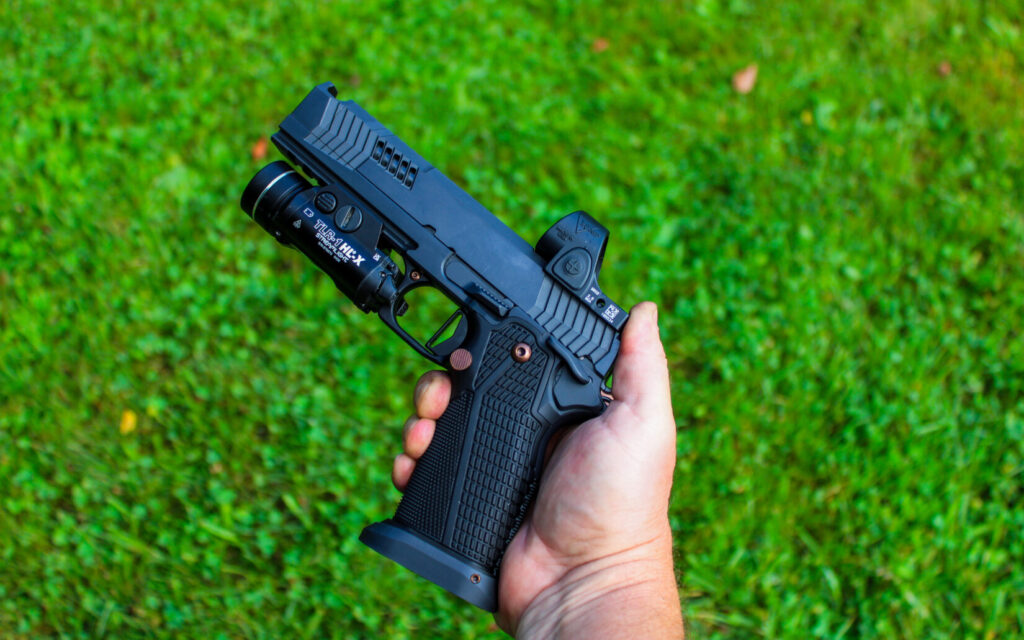 A man holding a black pistol.