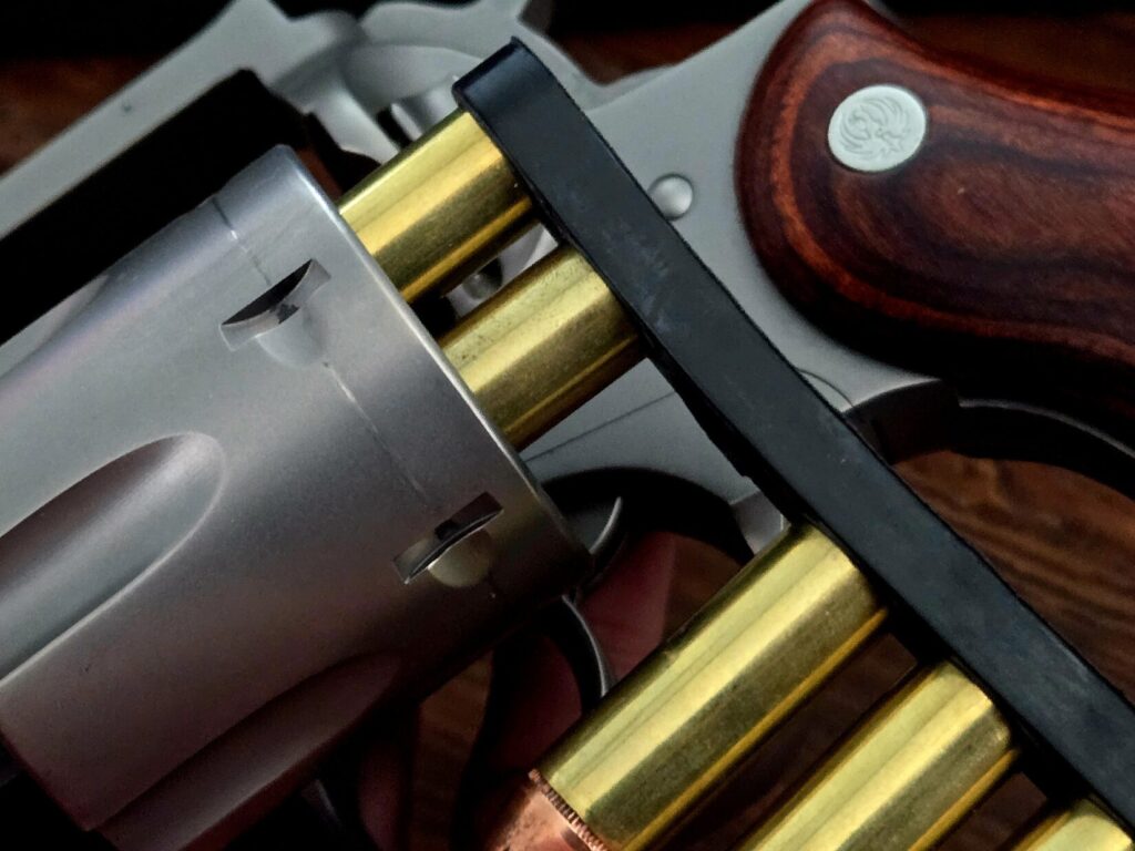 Speed strip loaded with two revolver cartridges, spaced for faster loading
