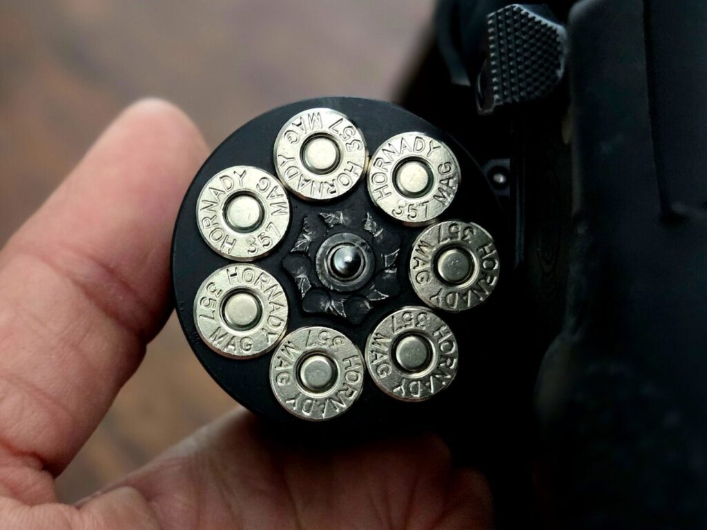 A revolver cylinder holding 7 shots of 357 magnum ammunition