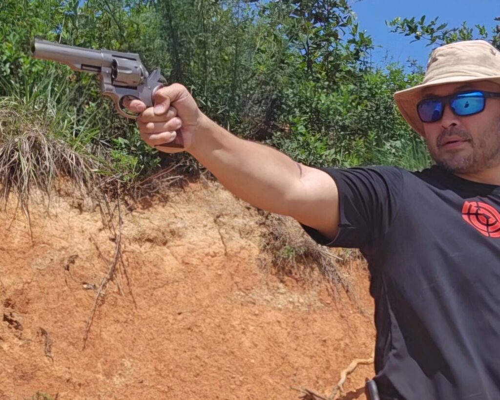 Kevin Estela taking a one-handed shot with the Ruger Redhawk at his local range.